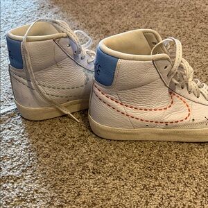 Nike woman’s White and Blue Sneakers with Orange Stitching